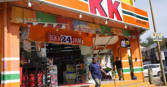 Malaysian convenience store owners charged over &#8216;Allah&#8217; socks that angered Muslims