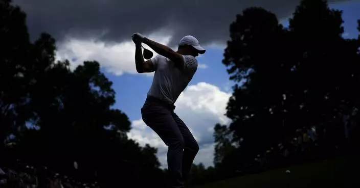 AP photographer gets in the right spot for a big swing at the Masters