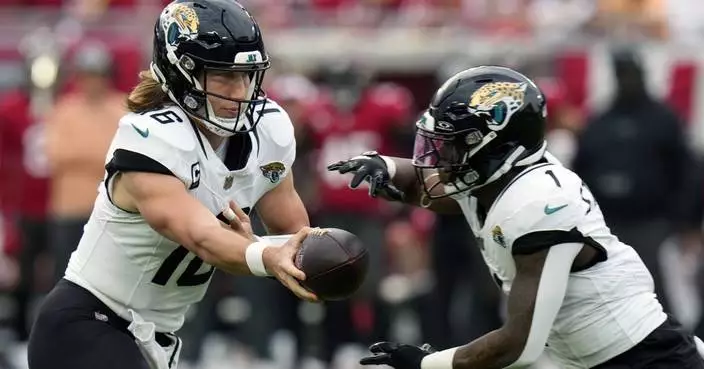 Jaguars pick up fifth-year options on contracts for QB Trevor Lawrence and RB Travis Etienne