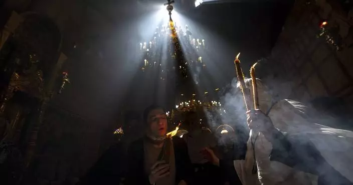 Cheers and flames as Orthodox worshipers greet the ancient ceremony of the &#8216;Holy Fire&#8217;