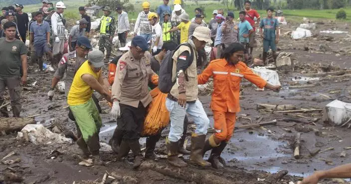 Indonesian rescuers search through rivers and rubble after flash floods that killed at least 52