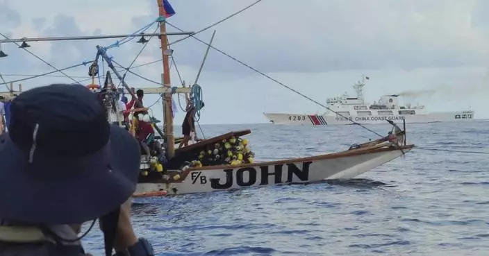 Filipino activists decide not to sail closer to disputed shoal, avoiding clash with Chinese ships