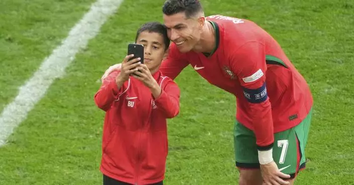 Four fans get on field for selfies with Cristiano Ronaldo during chaotic scenes at Euro 2024 match