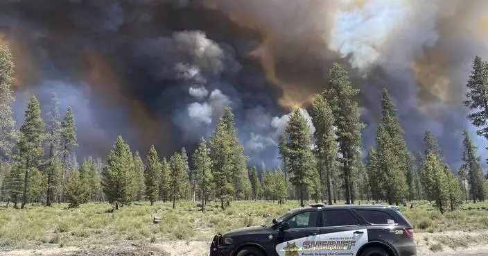 Wind-driven wildfire spreads outside a central Oregon community and prompts evacuations