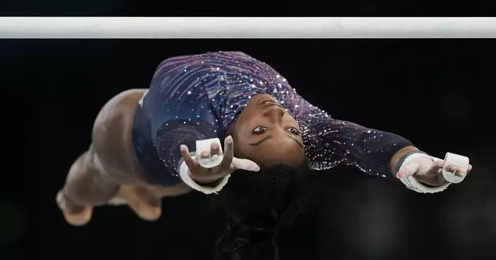 Simone Biles submits an original skill on uneven bars ahead of Paris Olympics