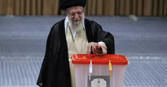 Reformist candidate narrowly leads hard-liner in early results from Iran’s election, state TV says