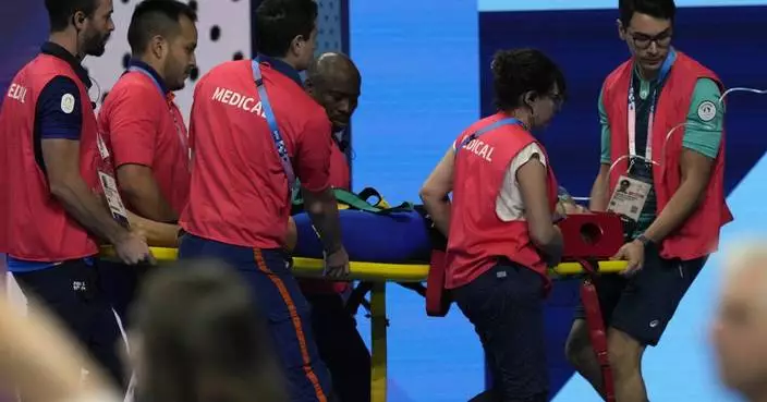 Swimmer Tamara Potocka collapses after a women’s 200-meter individual medley race at the Olympics