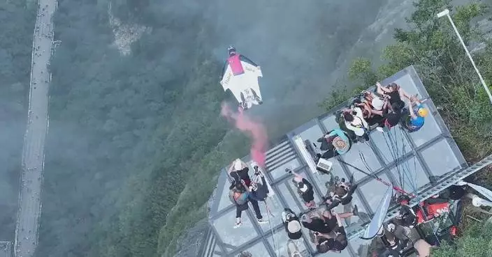 Tourists left in awe as wingsuit fliers soar through mountains of Zhangjiajie