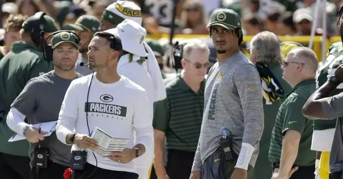 Warm day at Lambeau Field puts heat on Packers' O-linemen and causes one to vomit on football