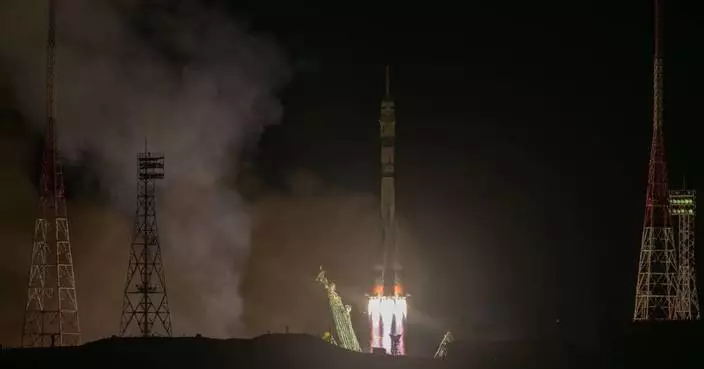 A Soyuz craft with 2 Russians and 1 American docks at the International Space Station