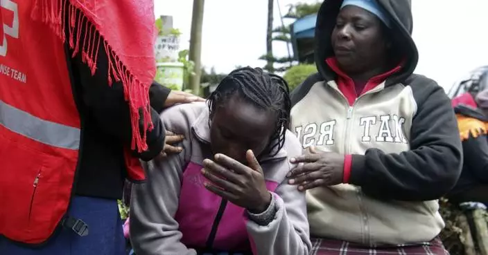 Kenyan officials remove bodies as they try to confirm the death toll from a school dormitory fire