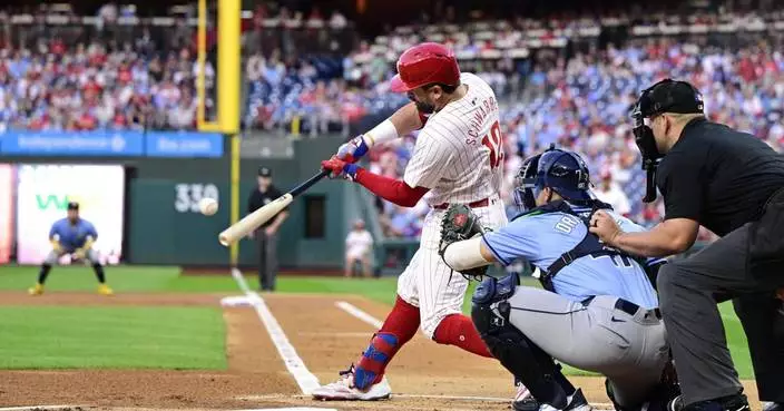 Phils&#8217; Schwarber sets MLB single-season mark with 14th leadoff HR before leaving with hurt elbow