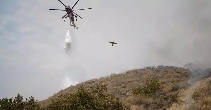 Wildfire east of LA threatens tens of thousands of homes and forces evacuations