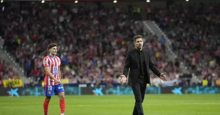 Madrid soccer derby interrupted after Atletico fans throw objects on the field