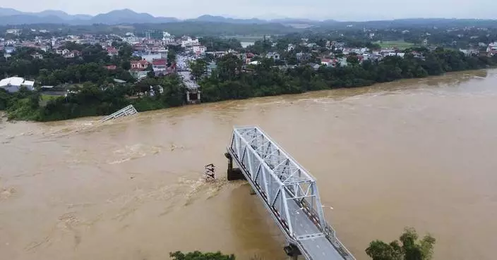 Bridge collapses as more rain falls in Vietnam and storm deaths rise to 21