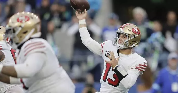 Brock Purdy throws for 3 TDs and the 49ers beat the Seahawks 36-24 to move atop division