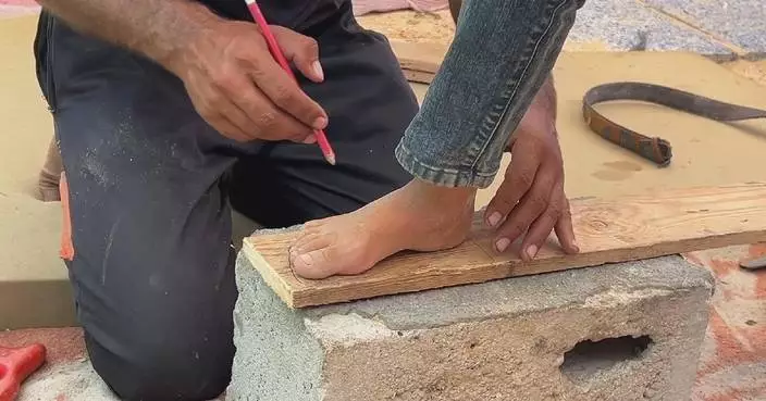 Gazan carpenter helps locals get back on feet by making affordable wooden shoes