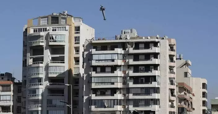 AP PHOTOS:  Images capture exact moments an Israeli missile strikes building in Beirut