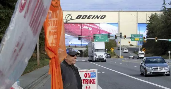 Striking Boeing workers are voting on a new contact offer as the company reports a $6 billion loss