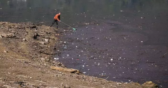 Residents and activists in central Bosnia clean up a lake after massive floods