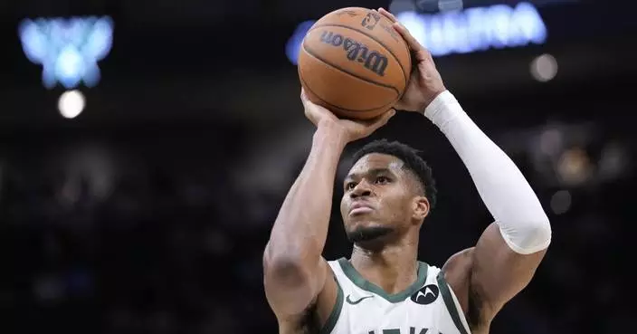 Two-time MVP Giannis Antetokounmpo shakes off knee woes to play opening night for Bucks