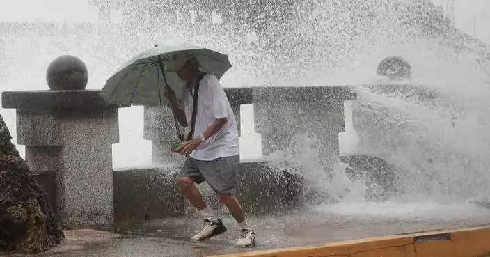 Typhoon bringing heavy rain slowly heads toward Taiwan, where 4,000 have evacuated