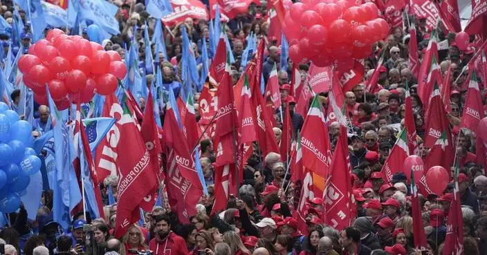 Thousands of workers march across Italy in general strike demanding better pay and services