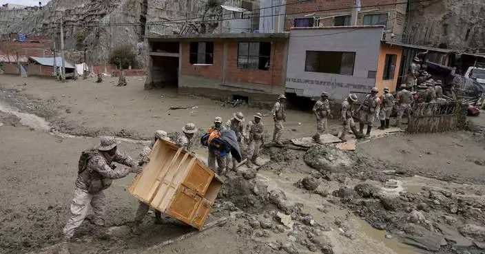 Heavy rains in Bolivia send mud crashing into the capital, leaving 1 missing and destroying homes