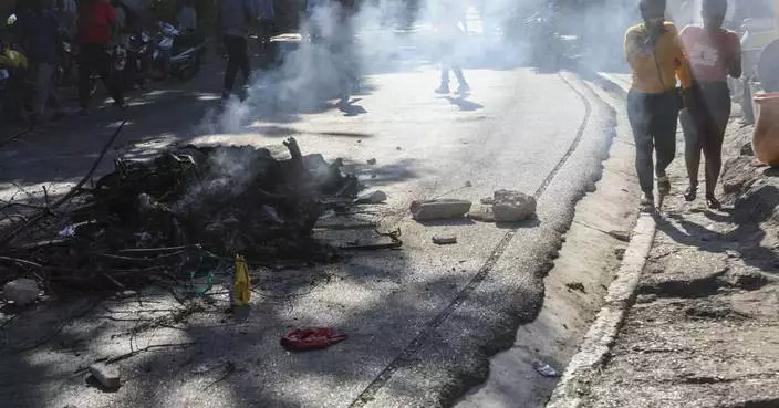 Residents in Haiti's capital stand with police in a battle to repel the latest gang attack