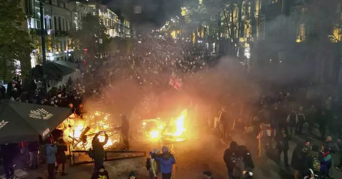 Georgian protesters and police clash after prime minister suspends talks on joining the EU