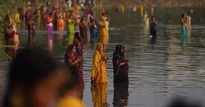 AP PHOTOS: Tens of thousands of Hindu devotees flock to rivers for prayers to the sun god