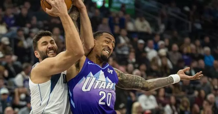 John Collins scores on a late dunk to lift Jazz past Mavericks for 1st home victory