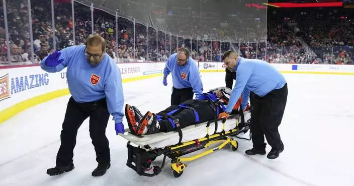 NHL referee Mitch Dunning taken off ice on stretcher after violent collision