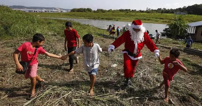 Santa braves the sticky heat of the Amazon jungle to bring gifts to children in Brazilian village