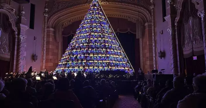 Michigan high school choir belts out holiday tunes from a towering Christmas tree