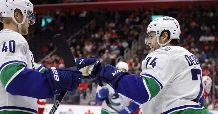 Jake DeBrusk scores hat trick, including OT game-winner, as Canucks top Red Wings 5-4