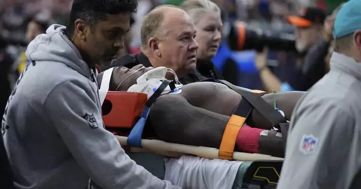 Miami WR DuBose taken off the field on a stretcher after hit to the head against Texans