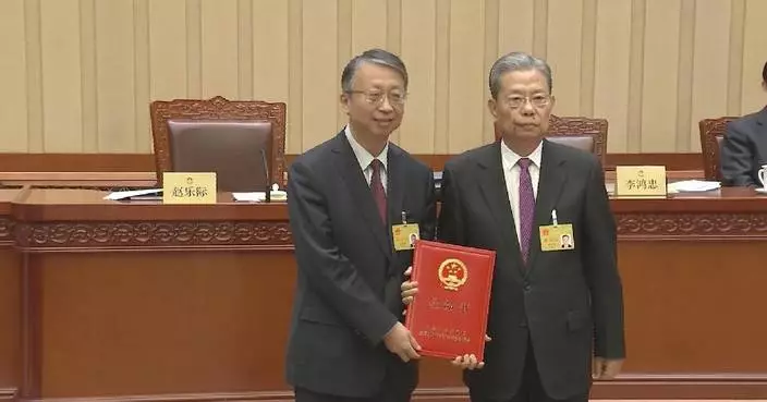 China's top legislator grants appointment letters to members of NPC's Macao Basic Law committee