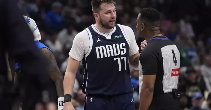 Mavs star Luka Doncic will be out about a month before check on calf injury, AP source says