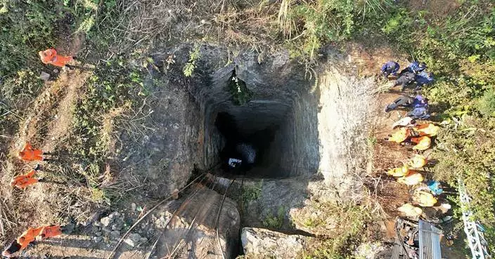 Indian army divers retrieve the body of one of at least 9 miners trapped in a flooded coal mine