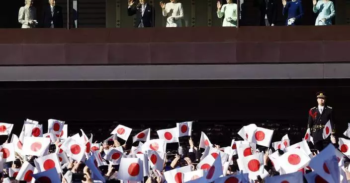 Japanese emperor and his family greet flag-waving crowd at the palace for New Year's