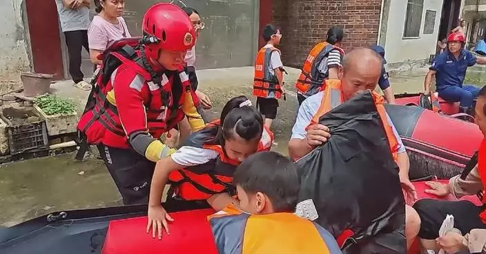 Rescue teams rush to save stranded locals after heavy rain hits Guangxi