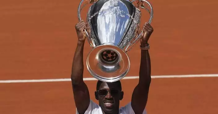 PSG star Dembélé raises Champions League trophy at the French Open