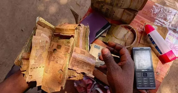 A rebel-held Congolese city uses damaged banknotes due to a cash shortage