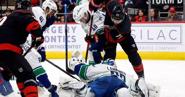 Aho scores in OT to lift Hurricanes to 4-3 win over Canucks