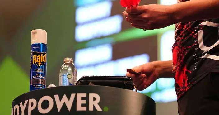 Darts player creates a buzz by bringing insect spray onto the stage at worlds