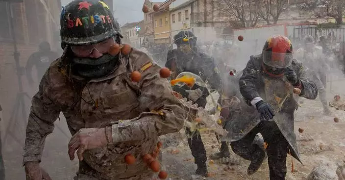 Photos show flour, eggs and firecrackers flying at Spain's Els Enfarinats festival