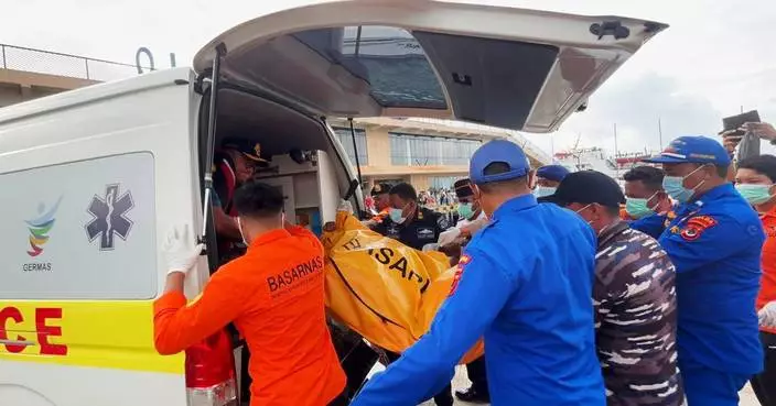 Indonesian rescuers find a body while searching for Spanish soccer coach and 3 children