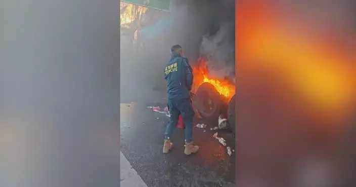Heroic motorist bravely crawls beneath burning truck to tackle blaze on highway