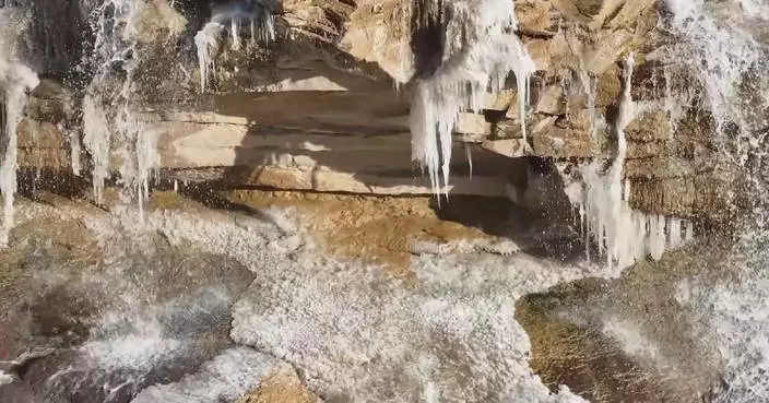 Flowing ice, icicles create winter landscape at Hukou Waterfall